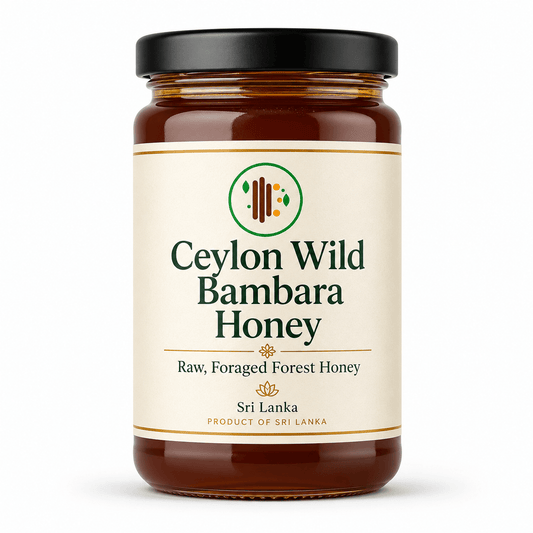Amber glass jar of raw foraged Bambara honey from Sri Lanka with a cream label featuring green and gold accents, black lid